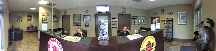 Photo of the Excalibur Auto Repair front desk and two service writers